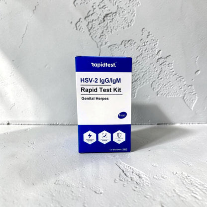HSV-2 IgG/IgM Rapid Test Kit packaging on a white background. Test at home for genital herpes and get the results in 15 minutes - rapidtest.co