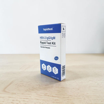 Rapidtest HSV-2 IgG/IgM Rapid Test Kit box on a wooden surface with a white background