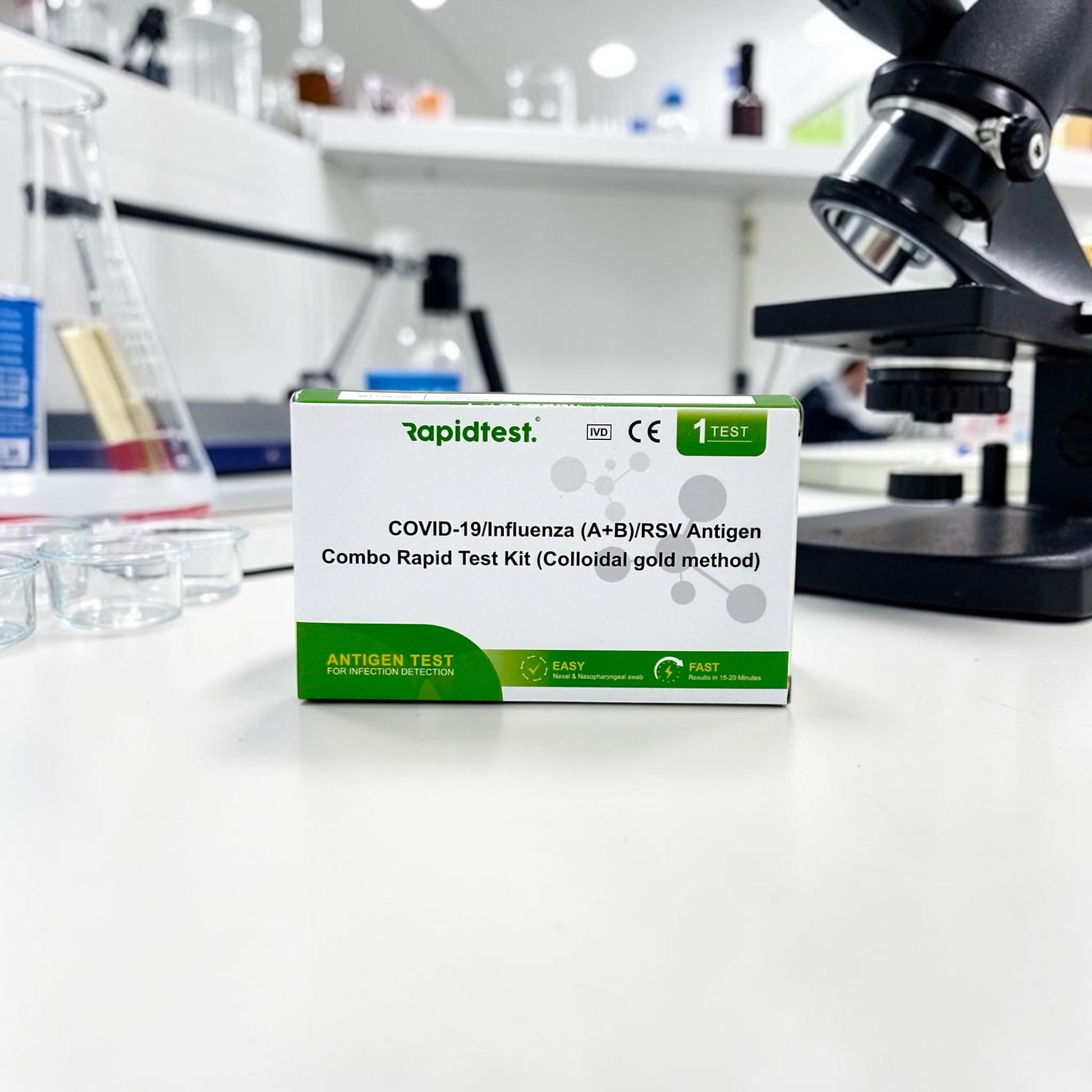 Rapidtest COVID-19/Influenza (A+B)/RSV Antigen Combo Rapid Test Kit in a laboratory setting with a microscope.
