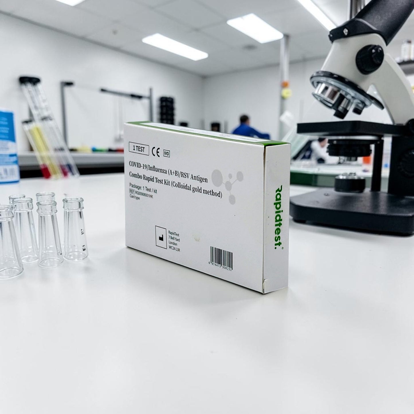 Test kit box on a lab counter with a microscope in the background