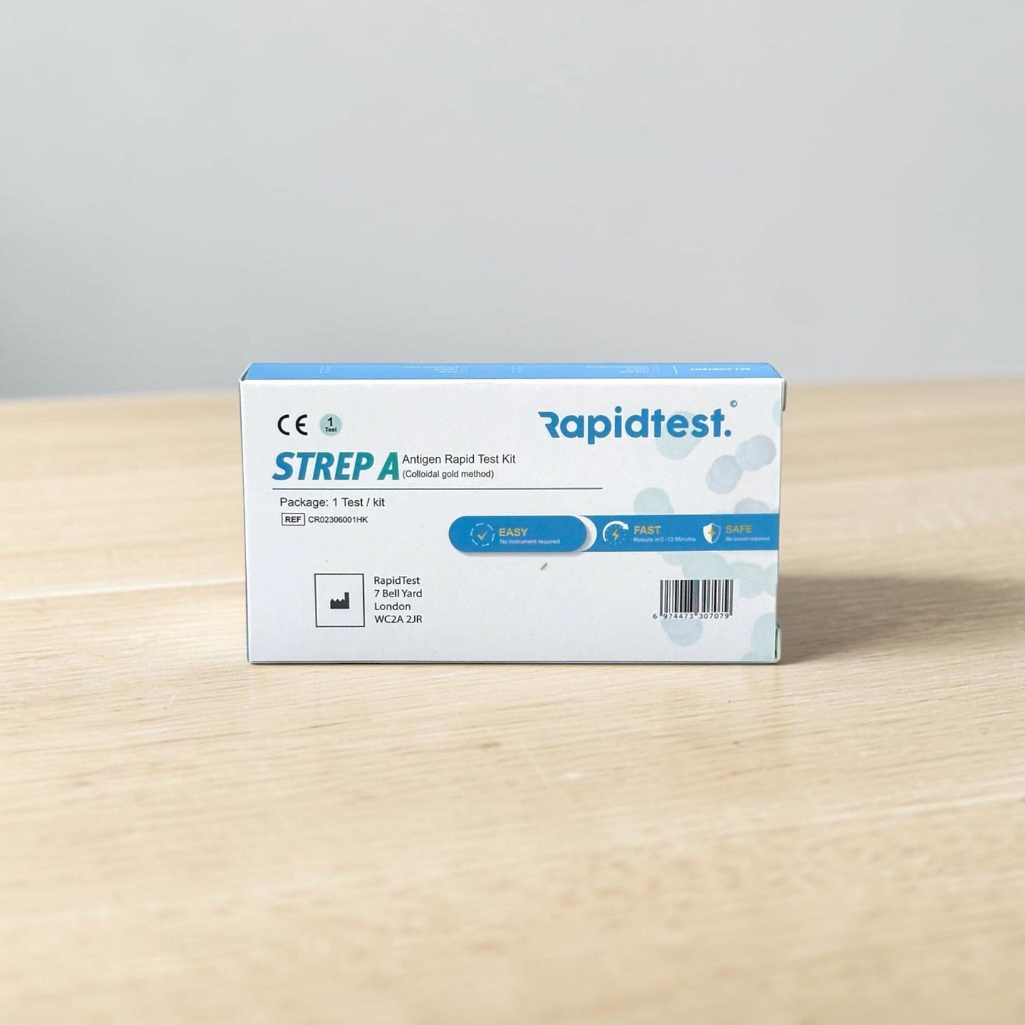 Rapidtest Strep A antigen rapid test kit box on a wooden surface with a gray background