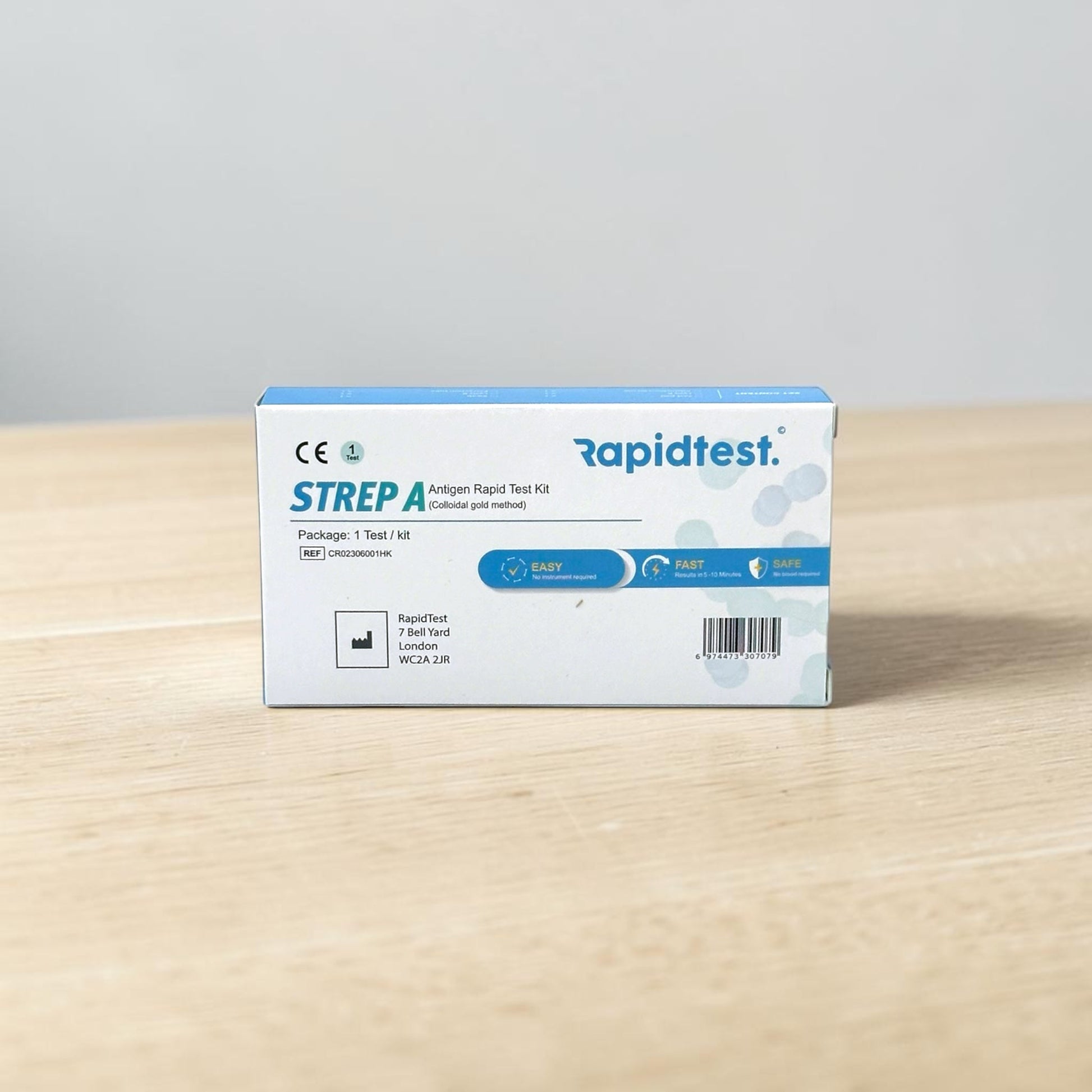 Rapidtest Strep A antigen rapid test kit box on a wooden surface with a gray background