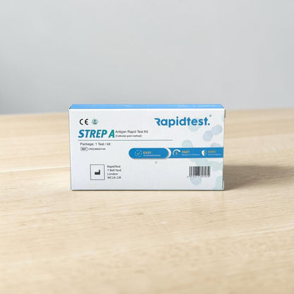 Rapidtest Strep A antigen rapid test kit box on a wooden surface with a gray background